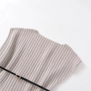 Minimalist oatmeal knit top with vertical ribbed texture and a slim black belted waistline