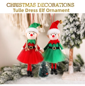 Close-up of two Christmas elf dolls with tulle skirts, bells, and red hanging ropes
