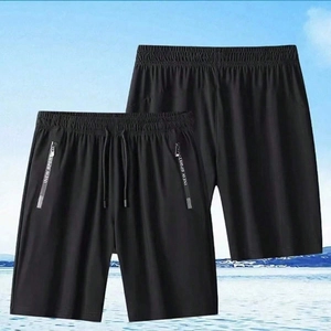 Detail view of black quick-dry sport shorts featuring zipper pockets and drawstring waist