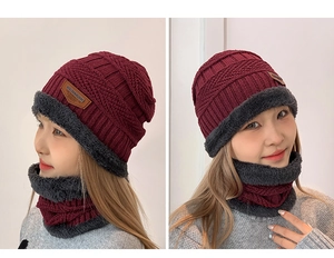 Detail of burgundy winter knit hat and neck warmer set with thick grey fleece lining