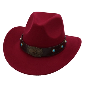 Detail of burgundy cowboy hat with brown leather band and turquoise star buckle