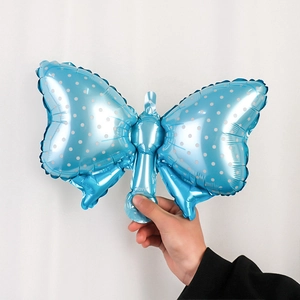 Sky blue bow-shaped foil balloon with white polka dots for birthday party decorations