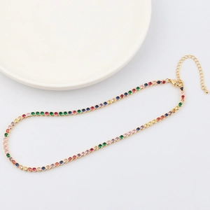 Detail of colorful tennis necklace with gold chain, lobster clasp, and adjustable links