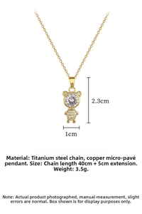 Detail showing a gold bear pendant with micro-paved zircons and cross chain link