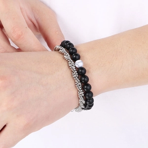 Close-up of men's double-layer bracelet with black matte beads and silver twisted rope chain