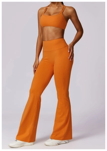 Detail of orange high-elastic yoga set with spaghetti strap bra and flared pants
