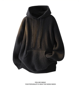 Close-up of chunky knit texture on oversize drawstring hoodie with kangaroo pocket