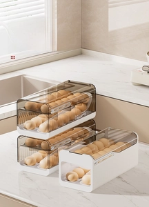 Detail view of the gravity rolling egg storage box with stackable design and transparent lid
