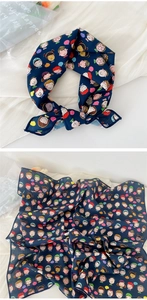 Detail of navy cotton linen square scarf with cartoon faces and colorful polka dot pattern