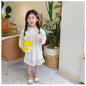 Toddler girl wearing white lace dress with a cute yellow heart bucket crossbody bag