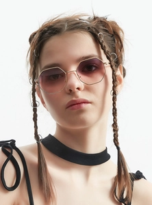 Close-up of gold octagon metal sunglasses with purple gradient lenses on a model