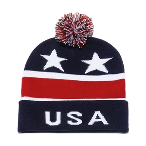 Detailed close-up of knitted USA flag beanie with pompom and patriotic star patterns