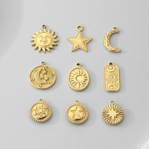 Set of 9 gold stainless steel celestial sun moon and star charms with geometric patterns