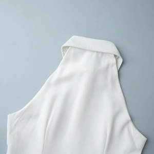 Detail shot of the white halter neck sleeveless dress with a lapel collar design