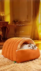 Detail of warm orange quilted pet sleeping bag with soft fleece lining and cat sleeping inside