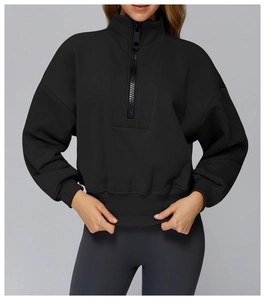 Close-up of black quarter-zip athletic sweatshirt with ribbed cuffs and stand collar