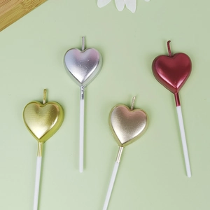 Set of four metallic heart-shaped birthday candles in gold, silver and red finishes