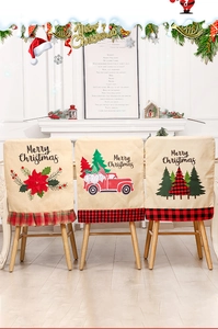 Close-up of three festive linen chair covers with gnome and truck Christmas prints