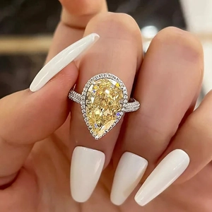 Luxury pear-cut yellow gemstone halo ring in silver with sparkling pavé setting