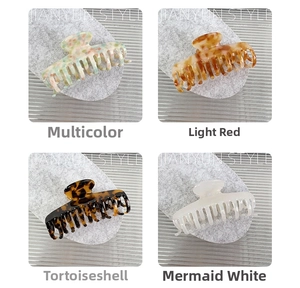 Detail view of acetate claw clips in floral, marble, tortoiseshell and pearl finishes