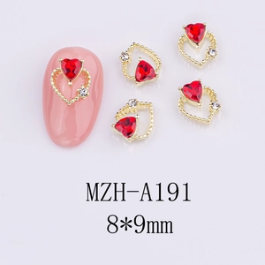 Detail view of 8x9mm hollow heart nail charm with red stone and gold alloy base