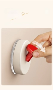 Close-up of a vacuum suction cup hook showing the folding mechanism for easy installation