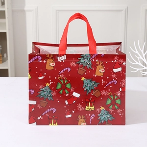 Red Christmas non-woven tote bag featuring festive elk and tree patterns for gift packaging