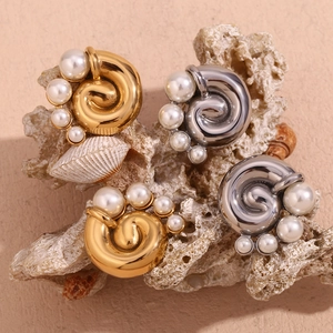 Vintage 18K gold and silver whirlpool pearl earrings set on coral and shells