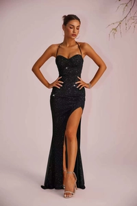 Detailed view of the sparkling black sequin fabric and elegant high slit on the dress
