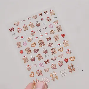 Detail of 3D embossed nail art stickers featuring cute coffee bears and brown puppies