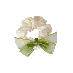 Elegant lily of the valley hair scrunchie with green bow and white satin floral details