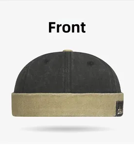 Front view of a two-tone docker cap in black and khaki with vintage patch detail