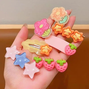 Colorful acrylic flower and strawberry hair clip set for girls held in hand