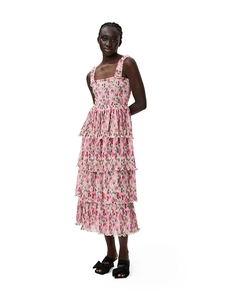 Detail of floral tiered maxi dress featuring smocked pink fabric and ruffled hemline