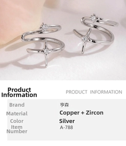 Detail of silver double spiral ring with star pattern and embedded zircon stones