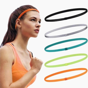 Detailed view of elastic sports headbands set in five vibrant colors worn by model