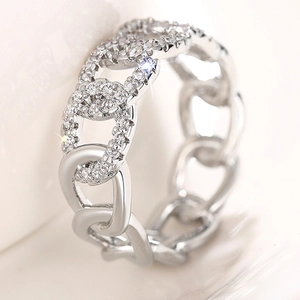 Macro detail of silver link ring with half-set pavé pavé cubic zirconia diamonds