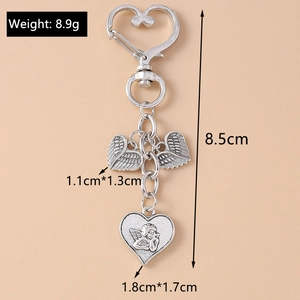 Detail showing dimensions of angel wing and heart keychain with a metal heart hook