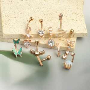 Set of rose gold belly rings with zircon hearts and snake designs on stone base