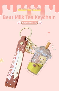 Detail of bear milk tea keychain with yellow bear charm and silicone wrist strap