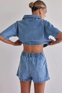 Back view of a casual washed denim two-piece set featuring shirt and elastic waist shorts