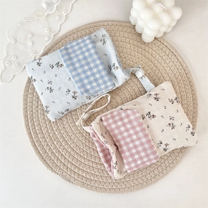 Detail of floral nurse pocket organizer with dual-layer storage and secure button straps