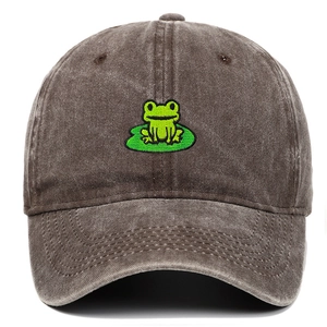 Detailed close-up of green frog embroidery on a vintage washed cotton baseball cap