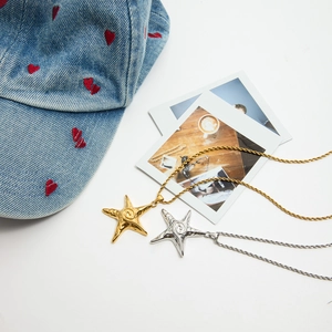 Detailed shot of gold and silver starfish pendant necklaces with elegant rope chain