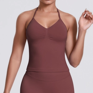 Detail of high-stretch terracotta ribbed sports bra with halter V-neck and ruched front