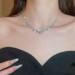 Close-up of sparkling cubic zirconia tennis necklace on woman's neck showing silver shine