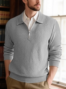 Detailed view of grey men's quarter-zip sweater with geometric knit pattern and collar