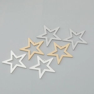 Detail of star-shaped DIY jewelry charms in gold and silver finish for necklaces