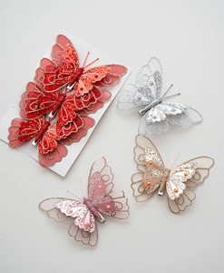 Close-up of glittery double-layered butterfly ornaments with sequins for Christmas trees