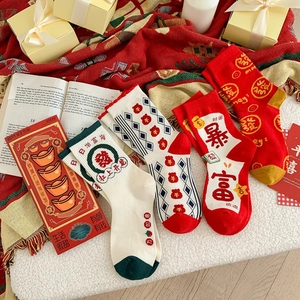 Detailed flat lay of red and white Chinese New Year socks with festive embroidery